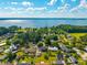 Aerial view of a residential neighborhood near a lake and surrounded by lush trees at 305 Whitewood Ct, Moncks Corner, SC 29461
