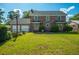 Large backyard featuring a detached garage with a basketball hoop and a well-maintained lawn at 305 Whitewood Ct, Moncks Corner, SC 29461