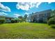 Expansive backyard with lush green grass, mature trees, and a detached garage at 305 Whitewood Ct, Moncks Corner, SC 29461