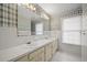 Bathroom with a long vanity, double sinks, large mirror, and bright wallpaper at 305 Whitewood Ct, Moncks Corner, SC 29461