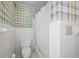 Bathroom with a toilet and shower with a white shower curtain, plus bold blue plaid wallpaper at 305 Whitewood Ct, Moncks Corner, SC 29461