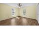 Bright bedroom with hardwood floors, ceiling fan, and two windows offering natural light at 305 Whitewood Ct, Moncks Corner, SC 29461