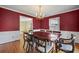 Formal dining room featuring hardwood floors, large windows, and inviting ambiance at 305 Whitewood Ct, Moncks Corner, SC 29461