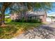 Traditional brick home with a well-manicured lawn and detached garage on a sunny day at 305 Whitewood Ct, Moncks Corner, SC 29461