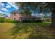 Charming two-story brick home with a well-manicured lawn and mature trees at 305 Whitewood Ct, Moncks Corner, SC 29461