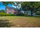 Charming two-story brick home with well-maintained lawn and mature trees offering ample shade at 305 Whitewood Ct, Moncks Corner, SC 29461