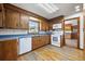 Functional kitchen equipped with white appliances, wood cabinets, and a window above the sink at 305 Whitewood Ct, Moncks Corner, SC 29461