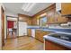 Bright kitchen featuring wood cabinets, blue countertop and a view into the adjacent dining area at 305 Whitewood Ct, Moncks Corner, SC 29461