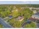 Aerial view showcases the home's setting amid trees and neighborhood buildings at 318 N Magnolia St, Summerville, SC 29483