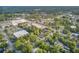 Wide aerial view showing the home's location in an urban landscape, with trees and nearby roads at 318 N Magnolia St, Summerville, SC 29483