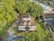 Aerial perspective of a two-story home with dormer windows, complemented by mature trees and a well-maintained yard at 318 N Magnolia St, Summerville, SC 29483