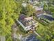 Aerial view of a home with a well-kept lawn and landscaping, surrounded by lush greenery and mature trees at 318 N Magnolia St, Summerville, SC 29483