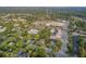 Aerial view showcasing a neighborhood with mature trees and commercial buildings at 318 N Magnolia St, Summerville, SC 29483