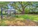 Spacious backyard with a large shade tree and outdoor seating area with a gazebo at 318 N Magnolia St, Summerville, SC 29483