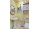 A yellow powder room featuring a pedestal sink, toilet, and vanity, creating a cheerful and compact space at 318 N Magnolia St, Summerville, SC 29483