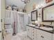 Bathroom featuring double sinks, a walk-in shower, decorative mirrors and accents providing a luxurious experience at 318 N Magnolia St, Summerville, SC 29483