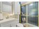Bathroom featuring white vanity with storage and glass enclosed shower with gold trim at 318 N Magnolia St, Summerville, SC 29483