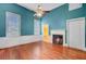 A bedroom featuring hardwood floors, a fireplace, and an ensuite bathroom, blending comfort and convenience at 318 N Magnolia St, Summerville, SC 29483