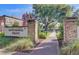 Hutchinson Square entrance with brick pillars, brick sidewalk, landscaping, and mature trees in the park at 318 N Magnolia St, Summerville, SC 29483