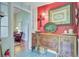 Red accent wall with furniture and decorations, with a view into the next living space at 318 N Magnolia St, Summerville, SC 29483