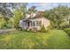 Classic white home with dark green shutters, complemented by a well-manicured lawn at 318 N Magnolia St, Summerville, SC 29483