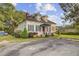 Beautiful two-story home with dormer windows, mature landscaping, and a welcoming front porch at 318 N Magnolia St, Summerville, SC 29483