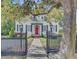 Inviting home featuring a red front door, black shutters, and a walkway leading to the entrance at 318 N Magnolia St, Summerville, SC 29483