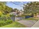 Charming two-story home with a gated entrance, featuring a red front door, dormer windows, and a welcoming landscaped yard at 318 N Magnolia St, Summerville, SC 29483