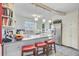 Updated kitchen with an island, bar stool seating, white cabinetry, stainless steel appliances, and open layout at 318 N Magnolia St, Summerville, SC 29483