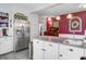 Spacious kitchen with stainless steel refrigerator, white cabinets, and a view of an adjacent stylishly decorated room at 318 N Magnolia St, Summerville, SC 29483
