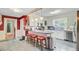 Updated kitchen with an island, bar stool seating, white cabinetry, stainless steel appliances, and modern lighting at 318 N Magnolia St, Summerville, SC 29483