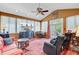 Bright living room with large windows, hardwood floors, ceiling fan, and comfortable seating arrangement at 318 N Magnolia St, Summerville, SC 29483