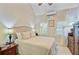 Bright main bedroom with a bed, bedside tables, and a decorative dresser, perfect for rest and relaxation at 318 N Magnolia St, Summerville, SC 29483