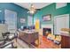 A green home office featuring hardwood floors, a fireplace, and a well-equipped workspace at 318 N Magnolia St, Summerville, SC 29483