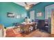 A functional home office with hardwood floors, a desk, and ample workspace, enhanced by natural light at 318 N Magnolia St, Summerville, SC 29483