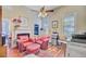 Well-lit office with fireplace, two armchairs, mini fridge, and ceiling fan providing a comfortable workspace at 318 N Magnolia St, Summerville, SC 29483
