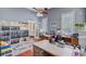 A bright office space featuring hardwood floors, built-in shelves, and a functional desk area at 318 N Magnolia St, Summerville, SC 29483