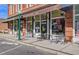 Storefront with outdoor seating and awnings with brick construction, advertising the 'Accent on Wine' wine bar at 318 N Magnolia St, Summerville, SC 29483