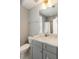Bathroom vanity featuring a gray cabinet, marble countertop, and modern fixtures at 34 Dereef Ct, Charleston, SC 29403