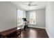 Bedroom with Peloton bike, bench, ceiling fan, hardwood floors, and natural light from windows at 34 Dereef Ct, Charleston, SC 29403
