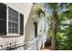 Charming home entrance with white stairs, black door, palm tree, and well-maintained landscaping at 34 Dereef Ct, Charleston, SC 29403