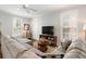 Cozy living room with a large sofa, TV, windows, and neutral decor for a relaxing atmosphere at 34 Dereef Ct, Charleston, SC 29403
