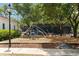 Community playground with modern play equipment, wood chip ground cover, and shade trees, ideal for Gathering fun at 34 Dereef Ct, Charleston, SC 29403