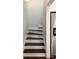 Stairway featuring dark wood treads and white risers leading to a refrigerator at 34 Dereef Ct, Charleston, SC 29403