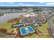 An aerial view featuring the community's amenities: pool, sports courts, parking and lake at 410 Eliston St, Summerville, SC 29486