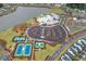 Aerial view showcases a resort-style pool, tennis courts, a basketball court and community lake at 410 Eliston St, Summerville, SC 29486