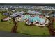 Aerial view of a community pool, water slide, palm trees and amenity center at 410 Eliston St, Summerville, SC 29486