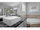 Bright bathroom featuring a soaking tub, granite counters, and a vessel sink at 410 Eliston St, Summerville, SC 29486