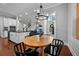 Bright dining area with a wood table, modern chandelier, and open view to the kitchen and living area at 410 Eliston St, Summerville, SC 29486