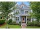 Charming two-story home with blue siding, white trim, and lush landscaping, showcasing curb appeal at 410 Eliston St, Summerville, SC 29486